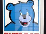 a poster of a blue bear with a big smile on it