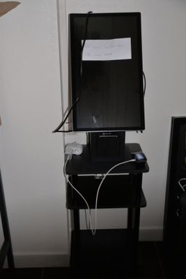 a small television on a small table in the corner of a room