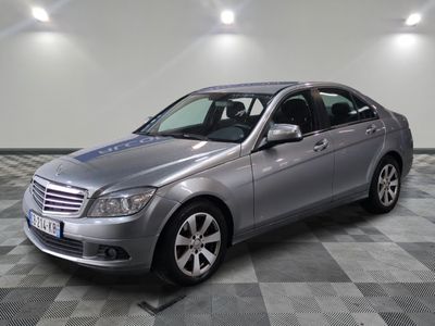 the mercedes c - class is parked on a checkered floor