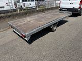 an image of a flat bed trailer parked in a parking lot