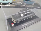 three toy cars in a display case on a table