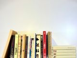 a lot of books that are stacked on top of each other