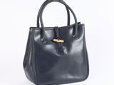 a black leather handbag with a wooden handle on a white background