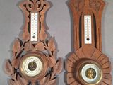 two clocks that are on the wall next to each other