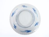 a blue and white bowl on a white surface