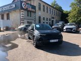 a black suv parked in front of a building