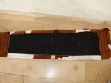 a brown and white rug on the floor of a bathroom