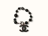 chanel bracelet with black onyx beads and a silver charm