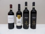 three bottles of red wine are lined up on a table