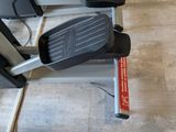 a close up of a stationary exercise bike on a tiled floor
