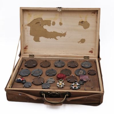 an old suitcase with a bunch of buttons in it
