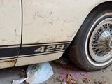 a dirty car parked on the side of the street