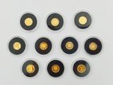 several gold coins are arranged in a circle on a white surface