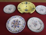 several plates and bowls on a table with a red table cloth