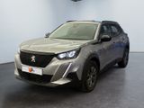 the front view of a silver car in a showroom