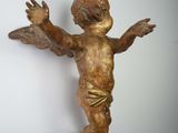 a statue of an angel hanging from a chain