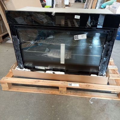 a large oven sitting on a pallet in a warehouse