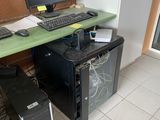 a computer desk with a monitor, keyboard, and mouse on it