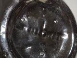 a close up of a black and white vase on a table