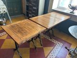 two tables that are sitting on a tiled floor