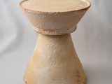 a small wooden stool sitting on a white surface