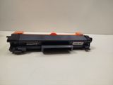a close up of a black toner on a white surface