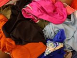 a pile of clothes that is sitting on a couch