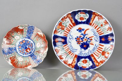 two plates with designs on them sitting on a table