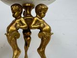 a gold table with a white bowl on top of it