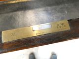 a brass plate on the back of a wooden bench