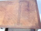 a wooden table with a wooden top and a drawer underneath it