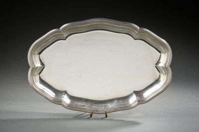 an antique silver plate on a stand on a gray surface