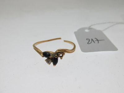 un gros plan d'une bague en or sertie de pierres noires