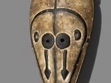 a close up of a mask on a gray surface