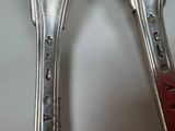 two spoons that are sitting next to each other on a table