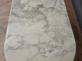 a marble table with a marble top on a wooden floor