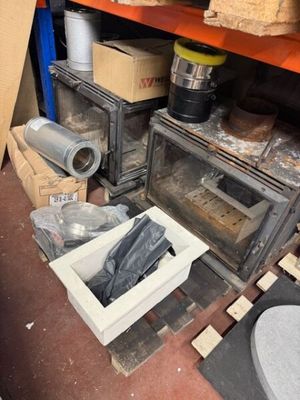 a small oven sitting in the middle of a room filled with boxes