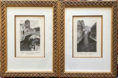 two framed pictures of a couple of buildings on the wall