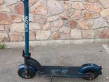 an electric scooter parked in front of a stone wall