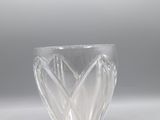 clear glass bowl on a white surface with a light in the background