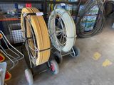 many different types of hoses and carts in a garage