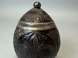 une boîte ancienne en métal argenté, ornée d'un motif floral sur le couvercle