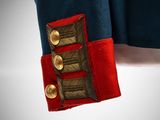 an image of a man in a military uniform with a red and blue jacket
