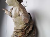a statue of a child hanging on a chain