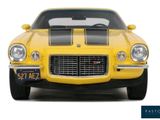 a yellow car with a black stripe on the front