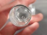 a person holding a glass of water in their hand