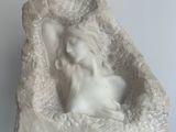a sculpture of a dog in a rock on a table