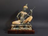 an image of a statue of a woman playing a musical instrument