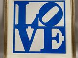 a framed picture of a blue and white love sign