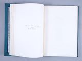 an open book on a table with a blue cover and white pages